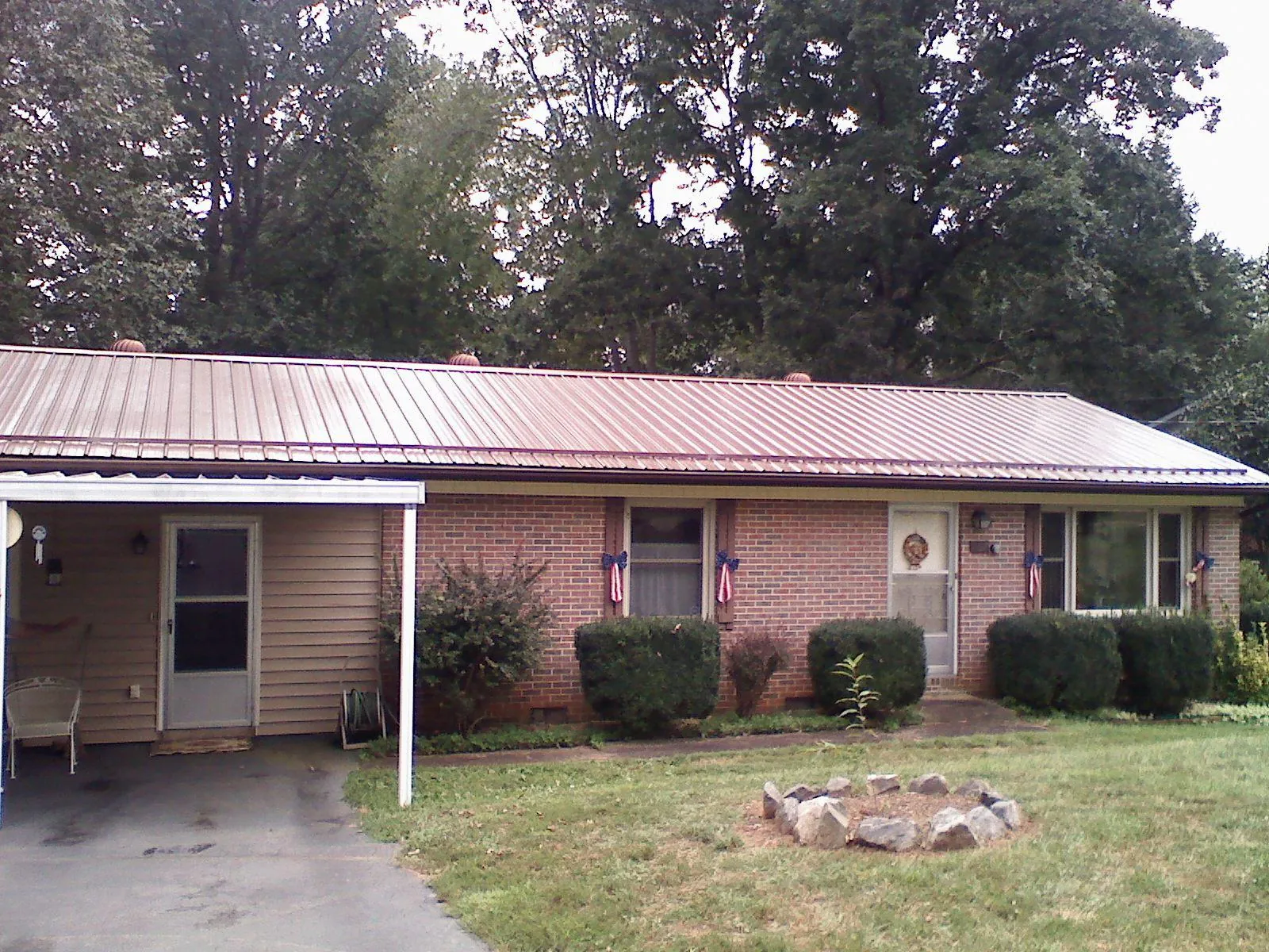 Bronze metal roof and carport on a brick ranch home — Roof Repair work by our crew in Wimbledon